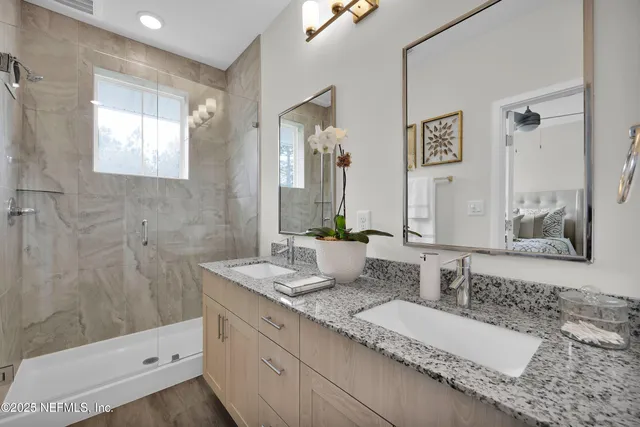 a bathroom with a double vanity sink and a mirror