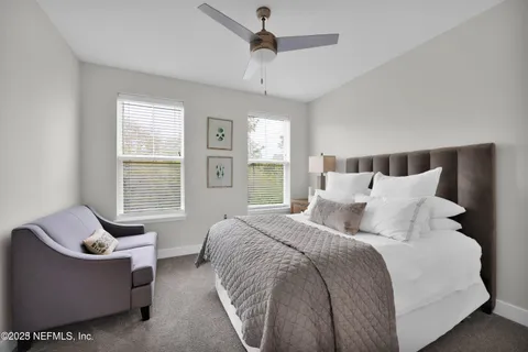 a bedroom with bed couch and window