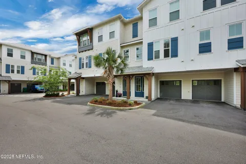 a front view of a building with that has plants