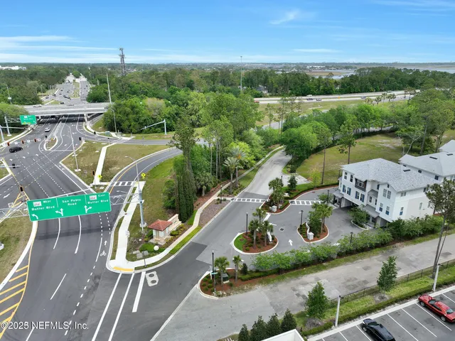 an aerial view of a house with backyard space and balcony