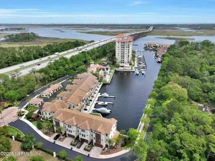 an aerial view of a house with garden space and ocean view