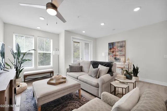 a living room with furniture and a large window