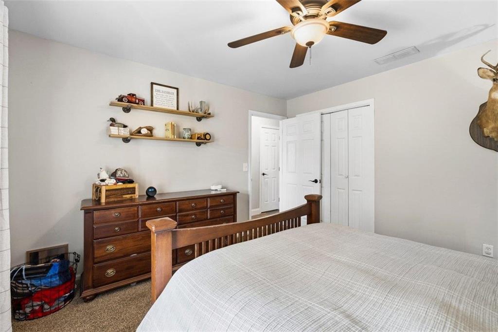 2777 Chickadee Drive Monroe, GA 30655 - Photo 25 of 36 a bedroom with a bed and cabinets