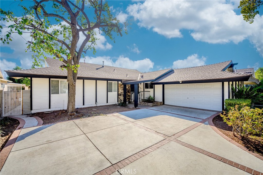 20352 Keswick Street Winnetka, CA 91306 - Photo 1 of 1 a view of a house with a large tree and a yard