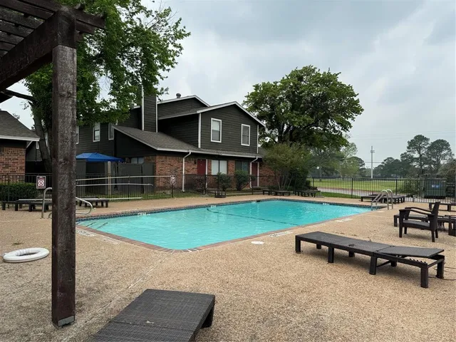 a view of a house with swimming pool and sitting area