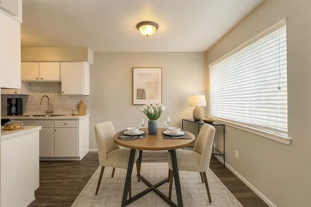 a view of a dining room with furniture and wooden floor
