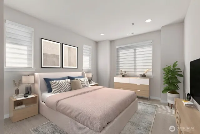 a bedroom with a large bed and a potted plant