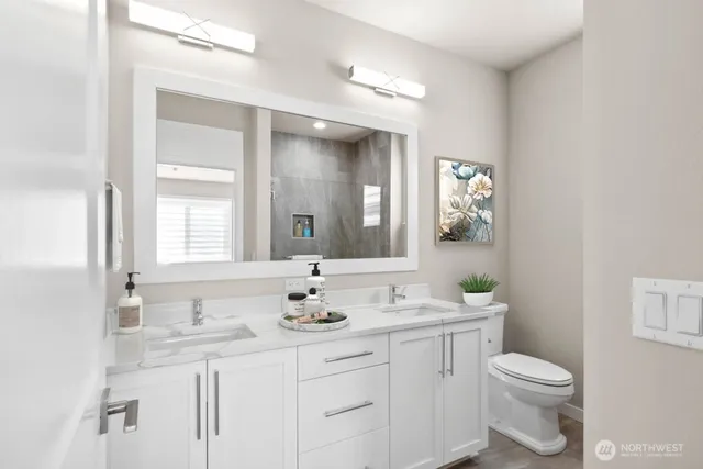 a bathroom with a toilet a sink and mirror