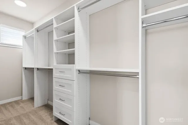 a view of walk in closet with empty racks