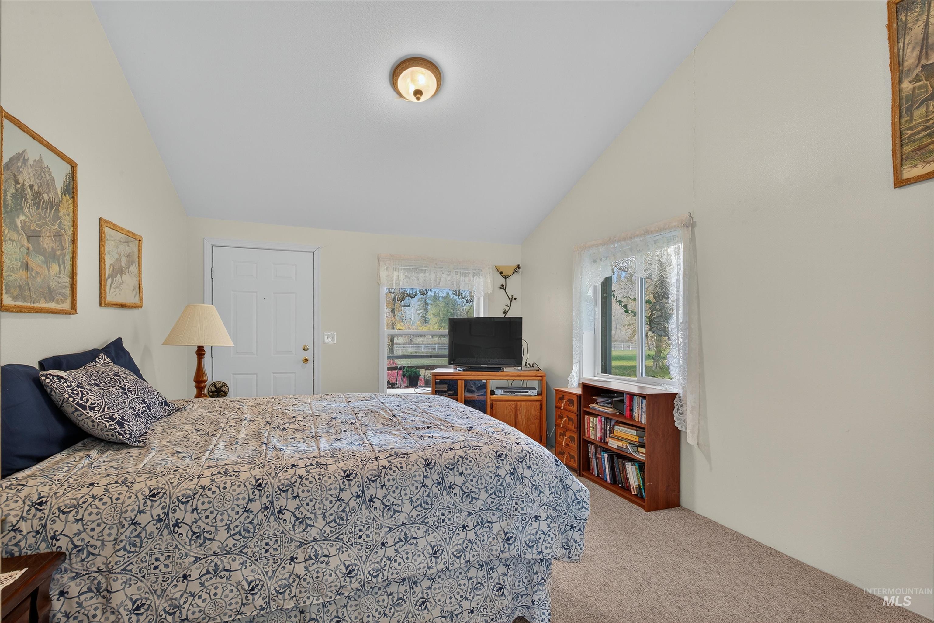 4151 Highway 13 Stites, ID 83552 - Photo 17 of 50 Bedroom with light colored carpet and vaulted ceiling