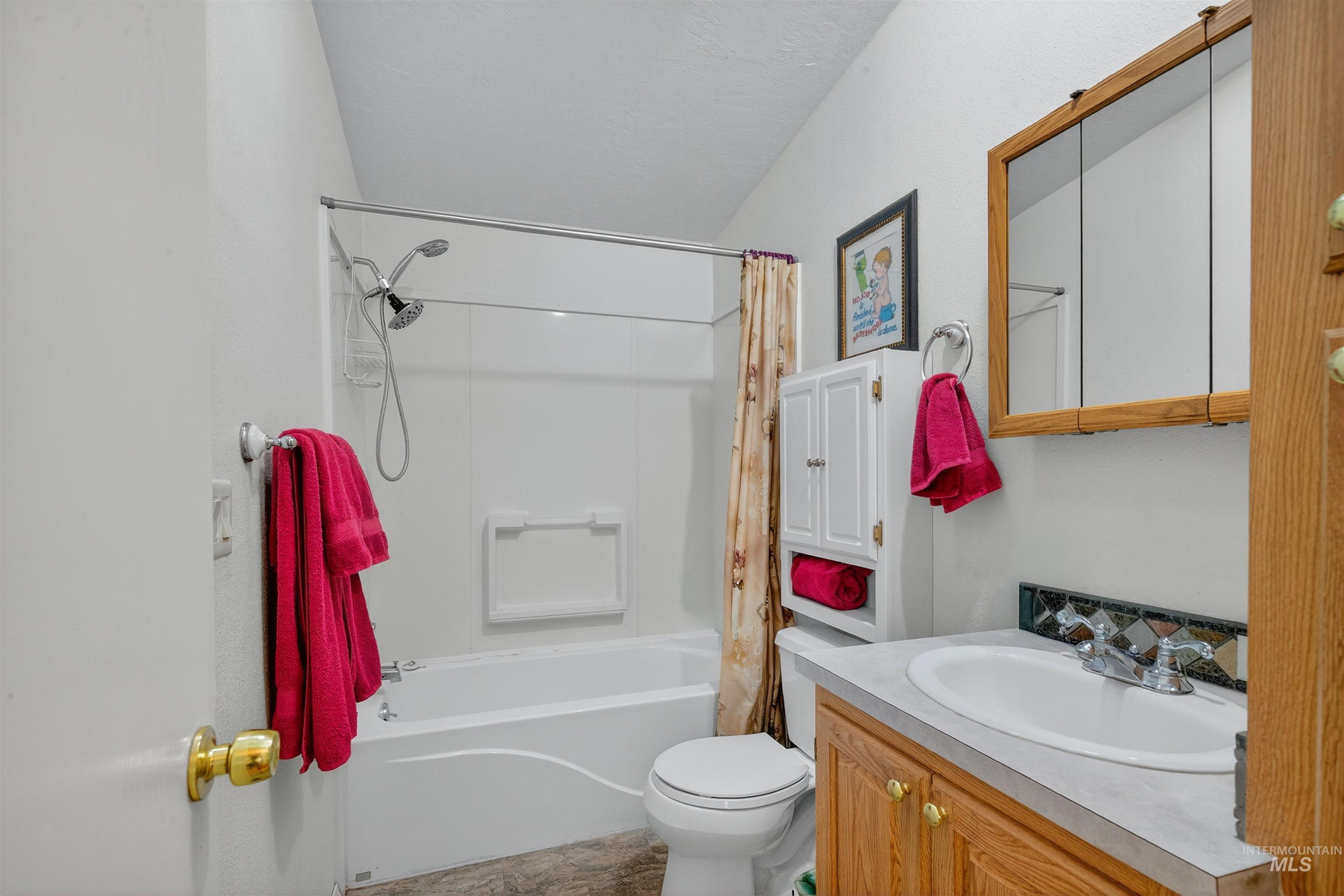 4151 Highway 13 Stites, ID 83552 - Photo 22 of 50 Bathroom featuring vanity and shower / bath combo with shower curtain