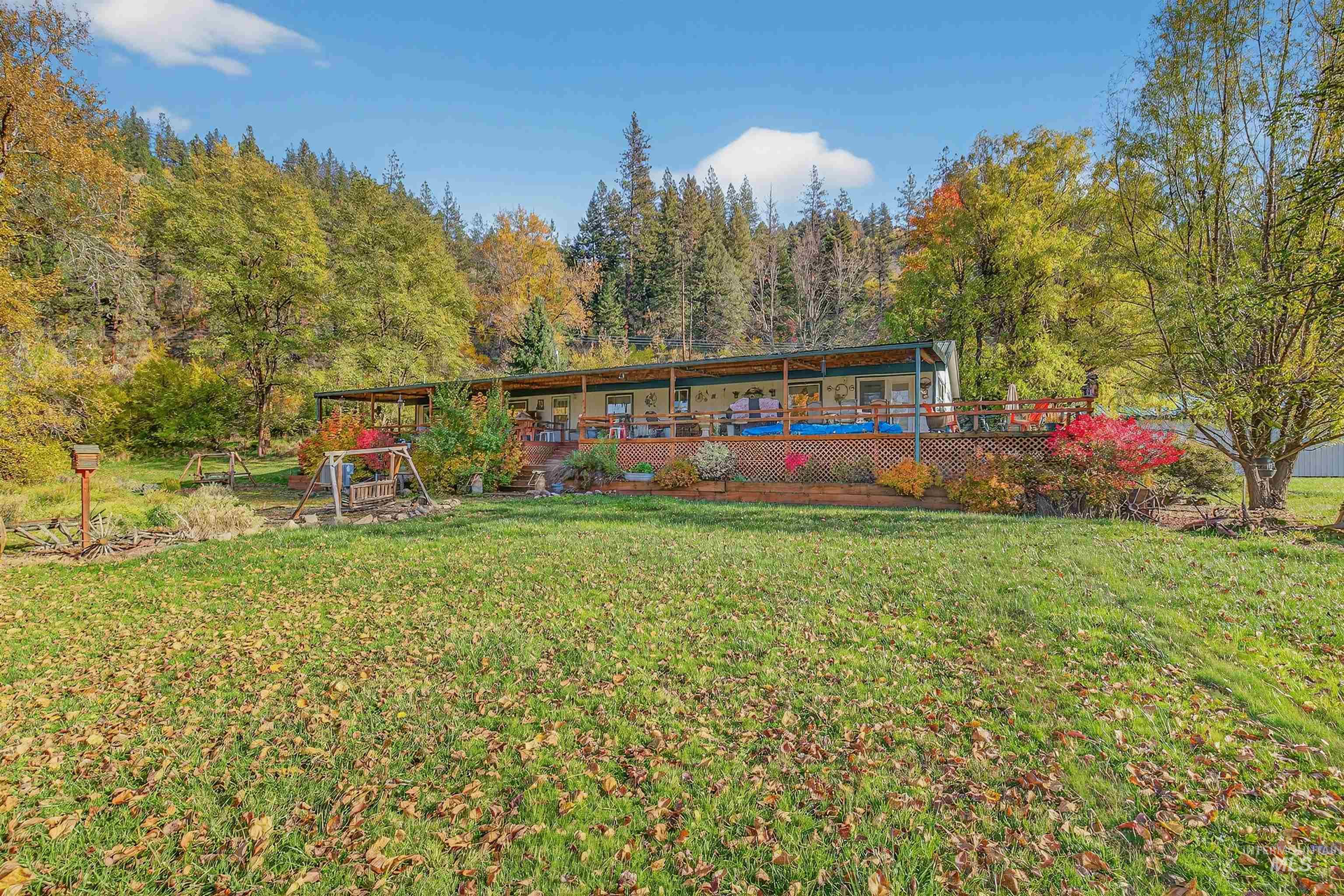 4151 Highway 13 Stites, ID 83552 - Photo 30 of 50 Back of property with a wooden deck, a lawn, and a wooded view