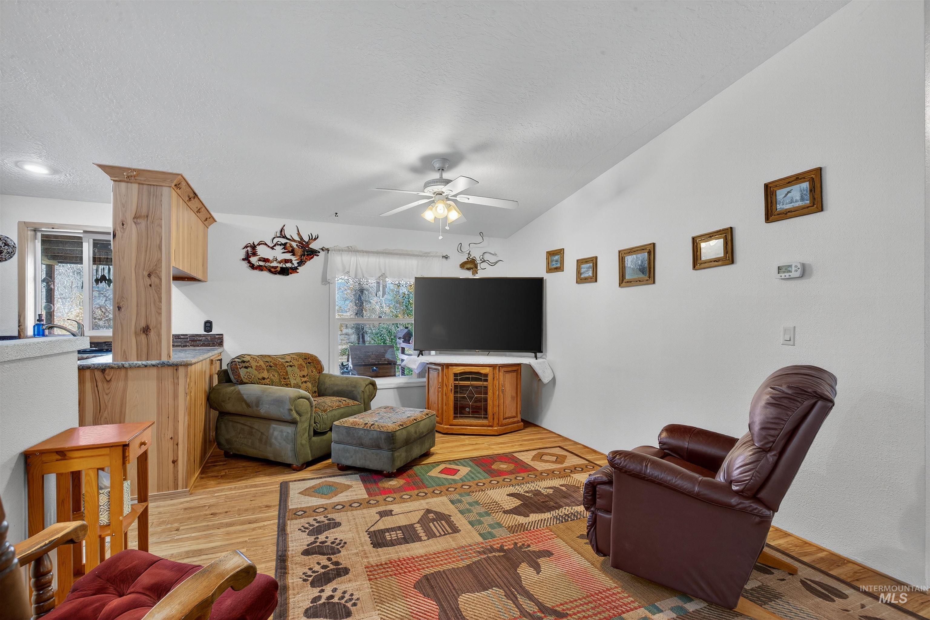 4151 Highway 13 Stites, ID 83552 - Photo 40 of 50 Living area with light wood-type flooring, ceiling fan, and a textured ceiling