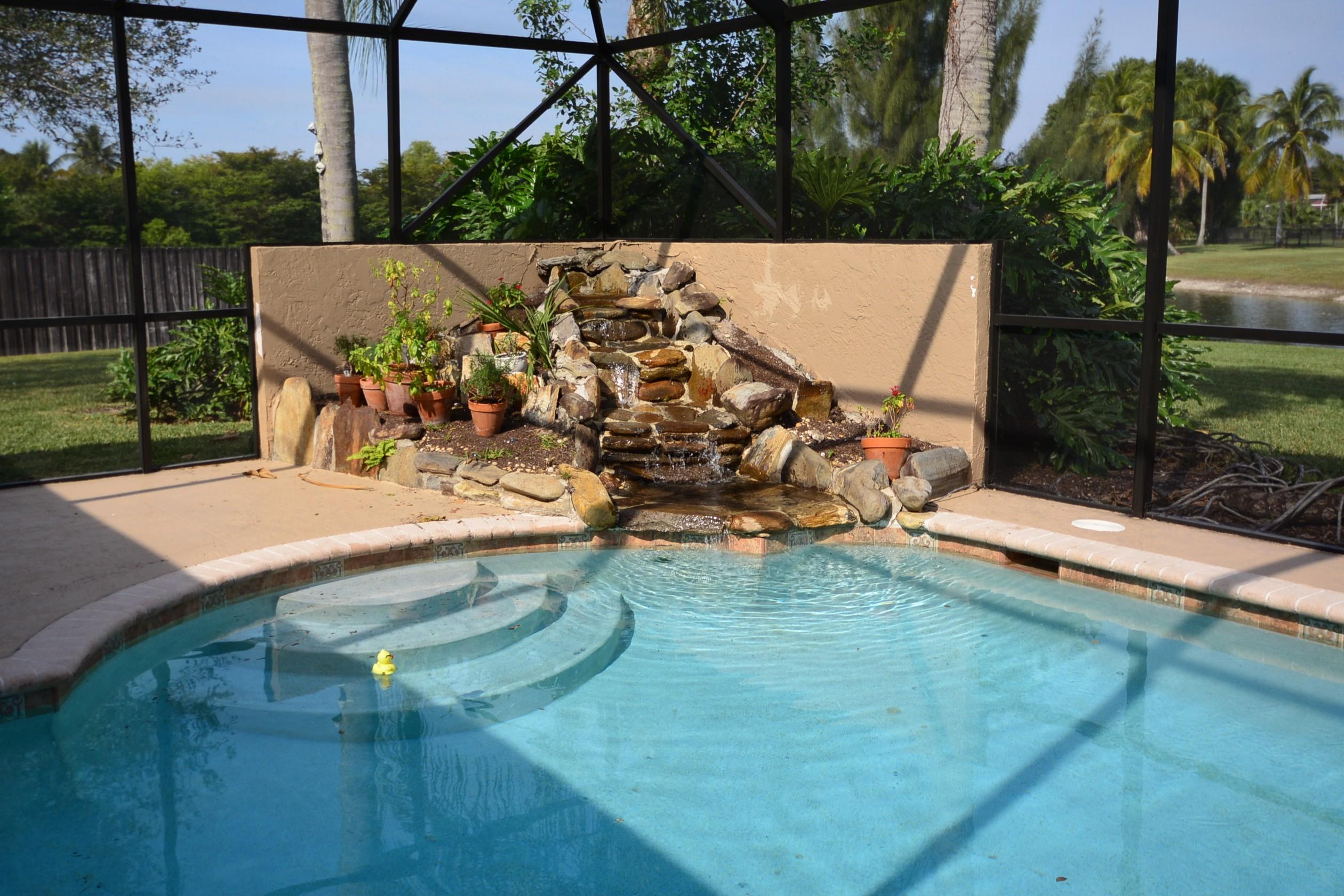 21620 Reflection Lane Boca Raton, FL 33428 - Photo 3 of 36 Solar Heated Pool with Waterfall
