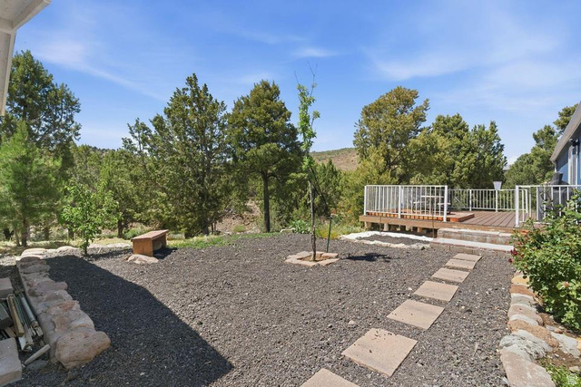 327 North Lodge Road Central, UT 84722 - Photo 31 of 45 Outdoor deck with white railing, wood-finish flooring, and a stone paver pathway