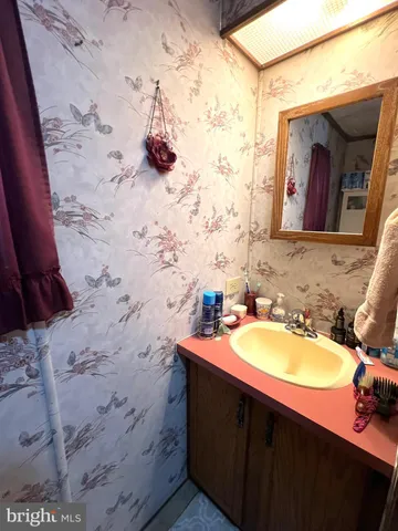 a bathroom with a sink vanity and mirror