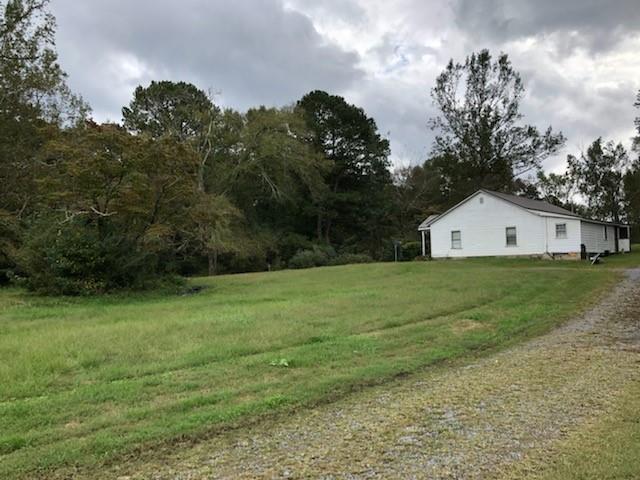 Pretty White Country home as you drive onto property.
