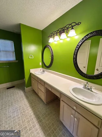a bathroom with a sink and mirror