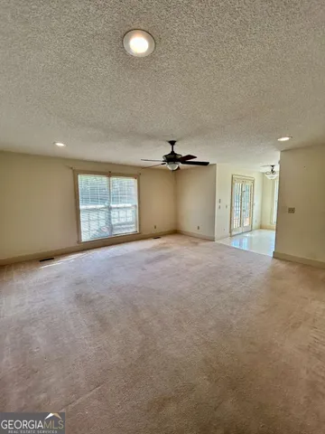 an empty room with a empty space and windows