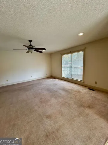 an empty room with a empty space and windows