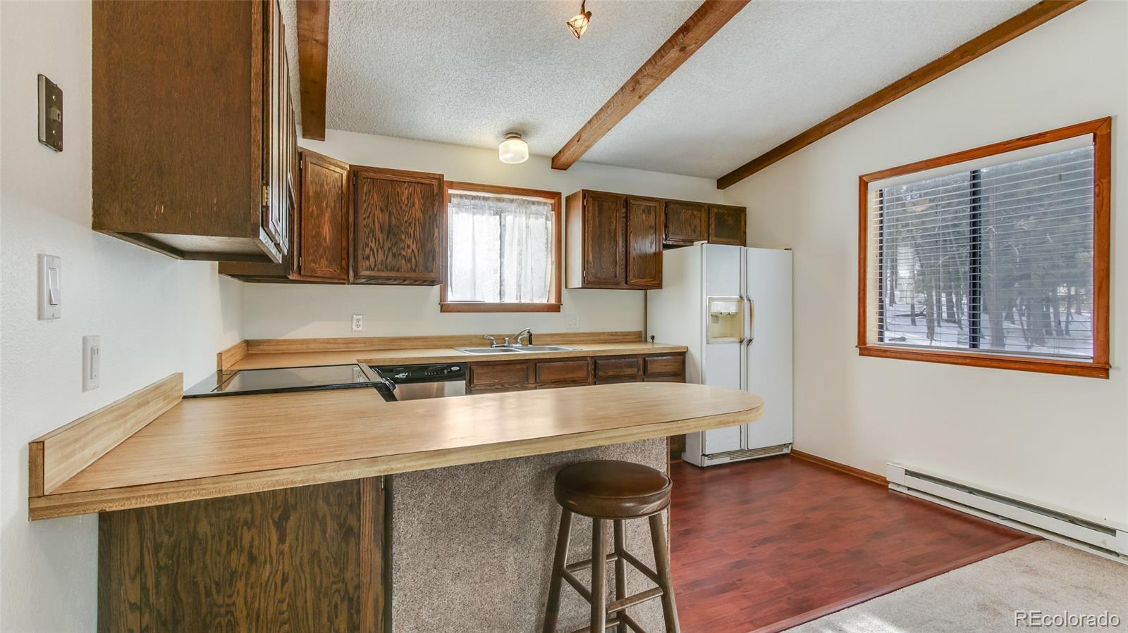 156 Ranchettes Road Bailey, CO 80421 - Photo 8 of 23 a kitchen with stainless steel appliances a stove a sink dishwasher and a refrigerator