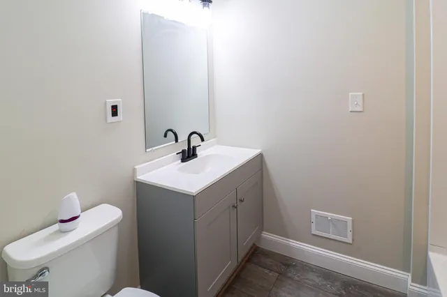 a bathroom with a sink toilet and vanity