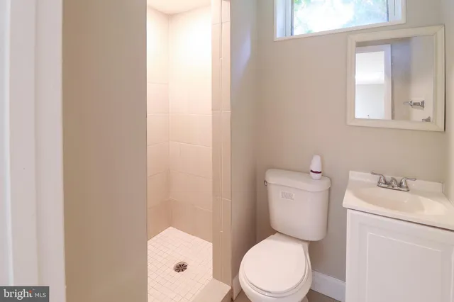 an empty room with white walls and tiles