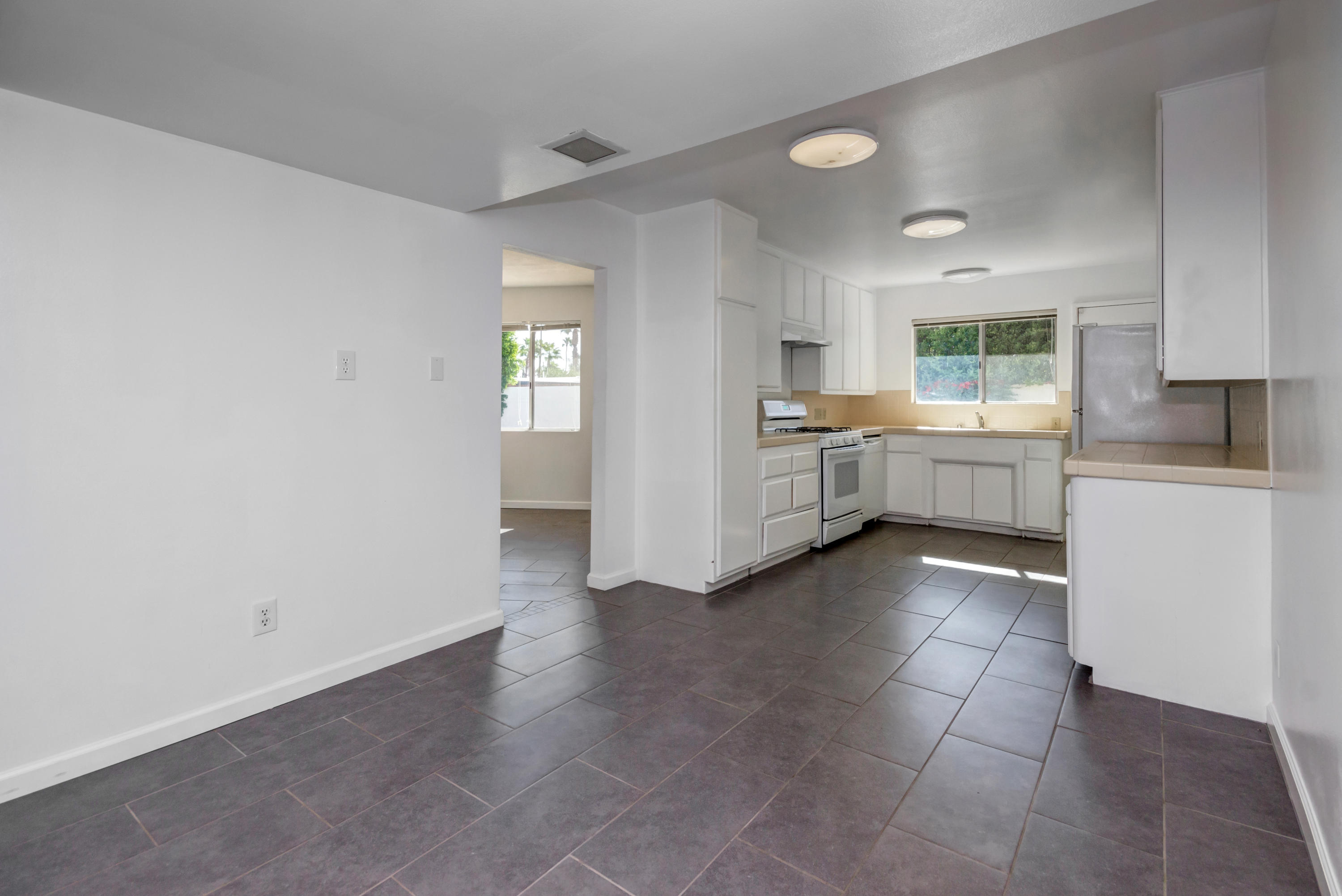 1253 Linda Vista Road Palm Springs, CA 92262 - Photo 12 of 29 a kitchen with a cabinets and white appliances