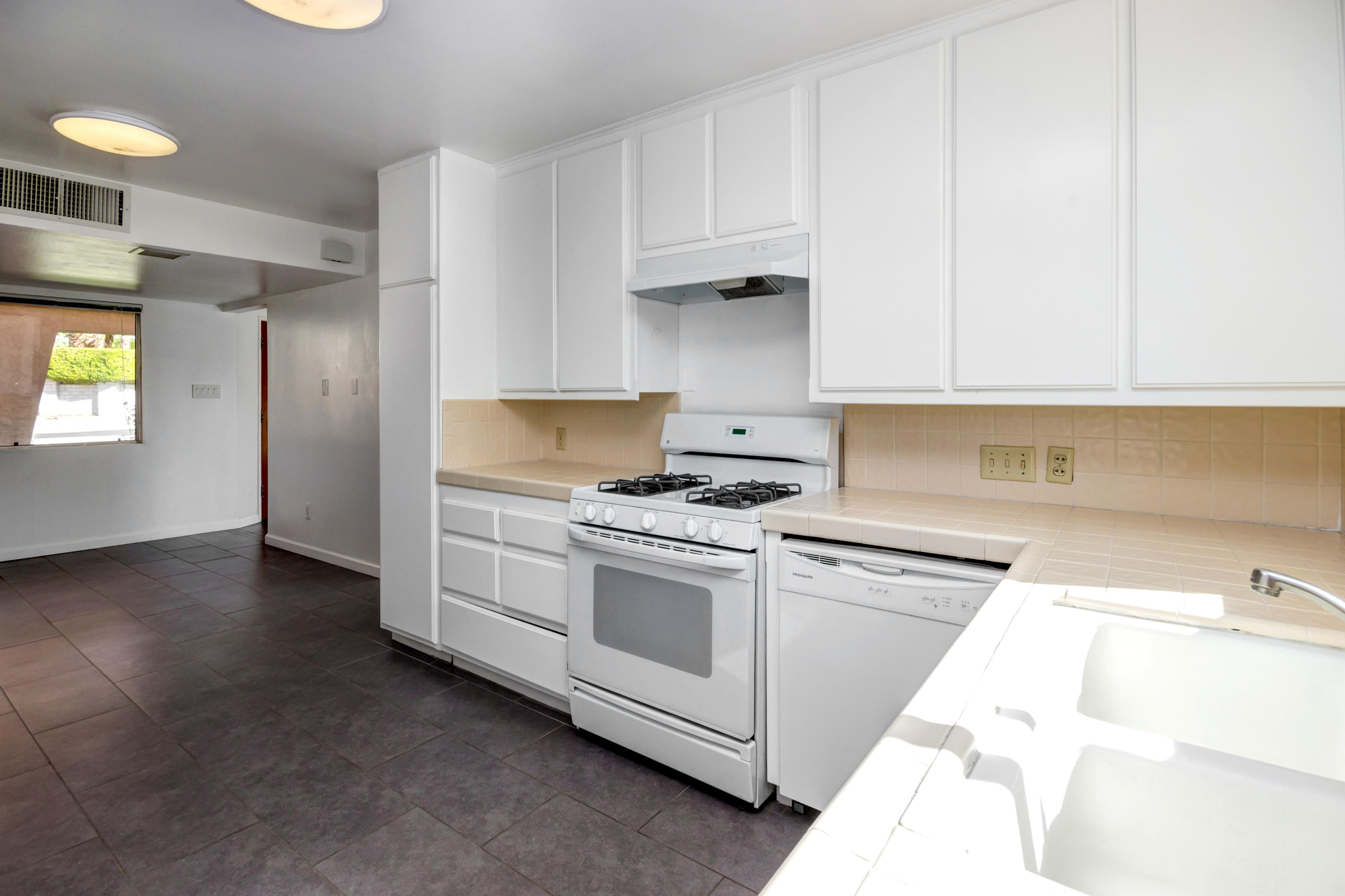 1253 Linda Vista Road Palm Springs, CA 92262 - Photo 15 of 29 a kitchen with cabinets appliances and a sink