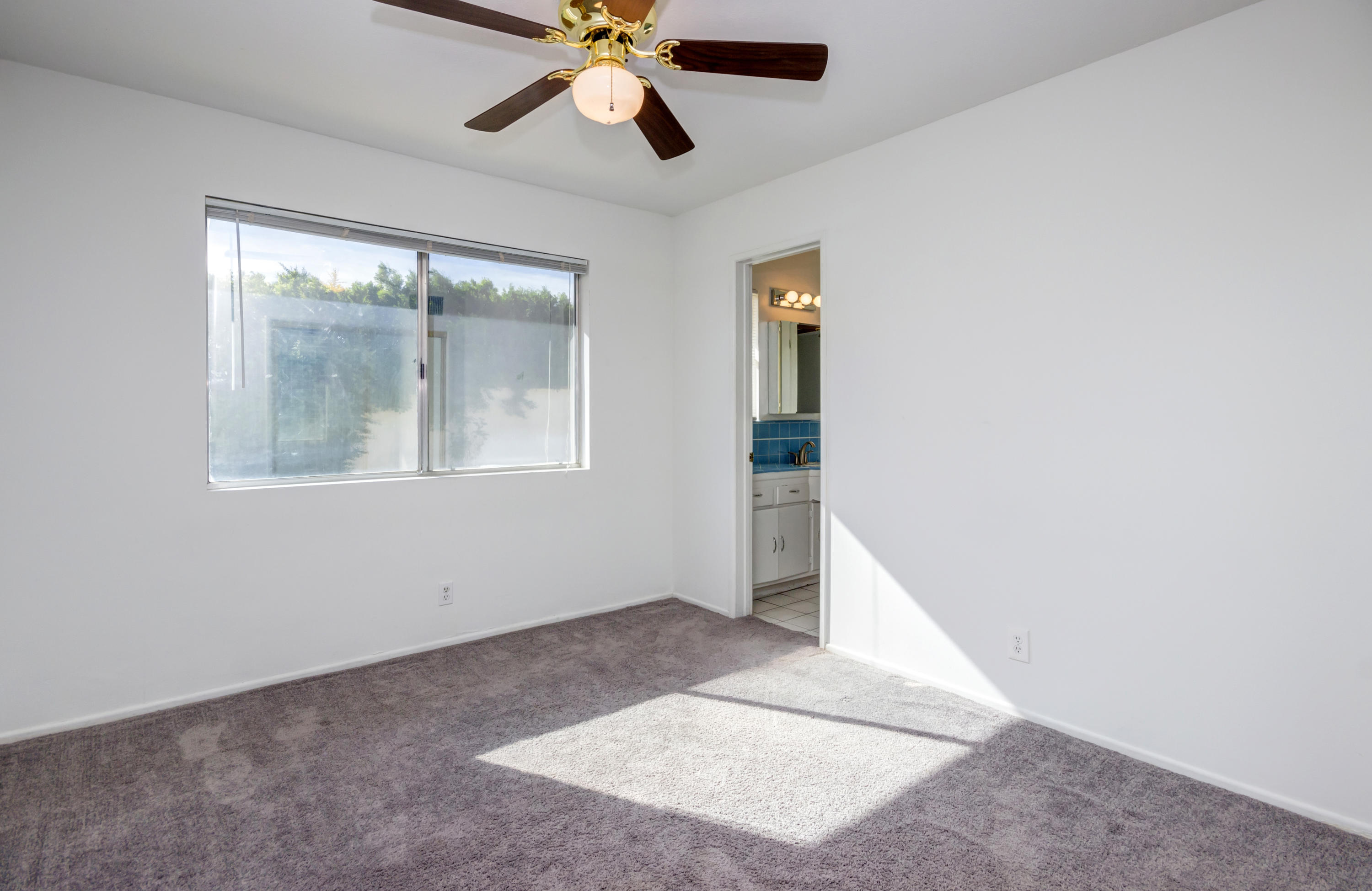 1253 Linda Vista Road Palm Springs, CA 92262 - Photo 19 of 29 an empty room with windows and fan