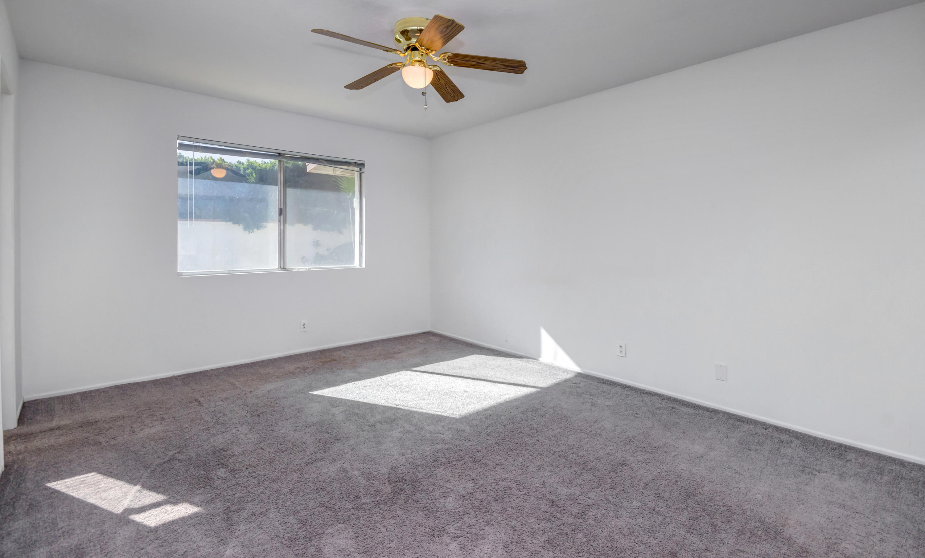 1253 Linda Vista Road Palm Springs, CA 92262 - Photo 23 of 29 an empty room with windows and fan