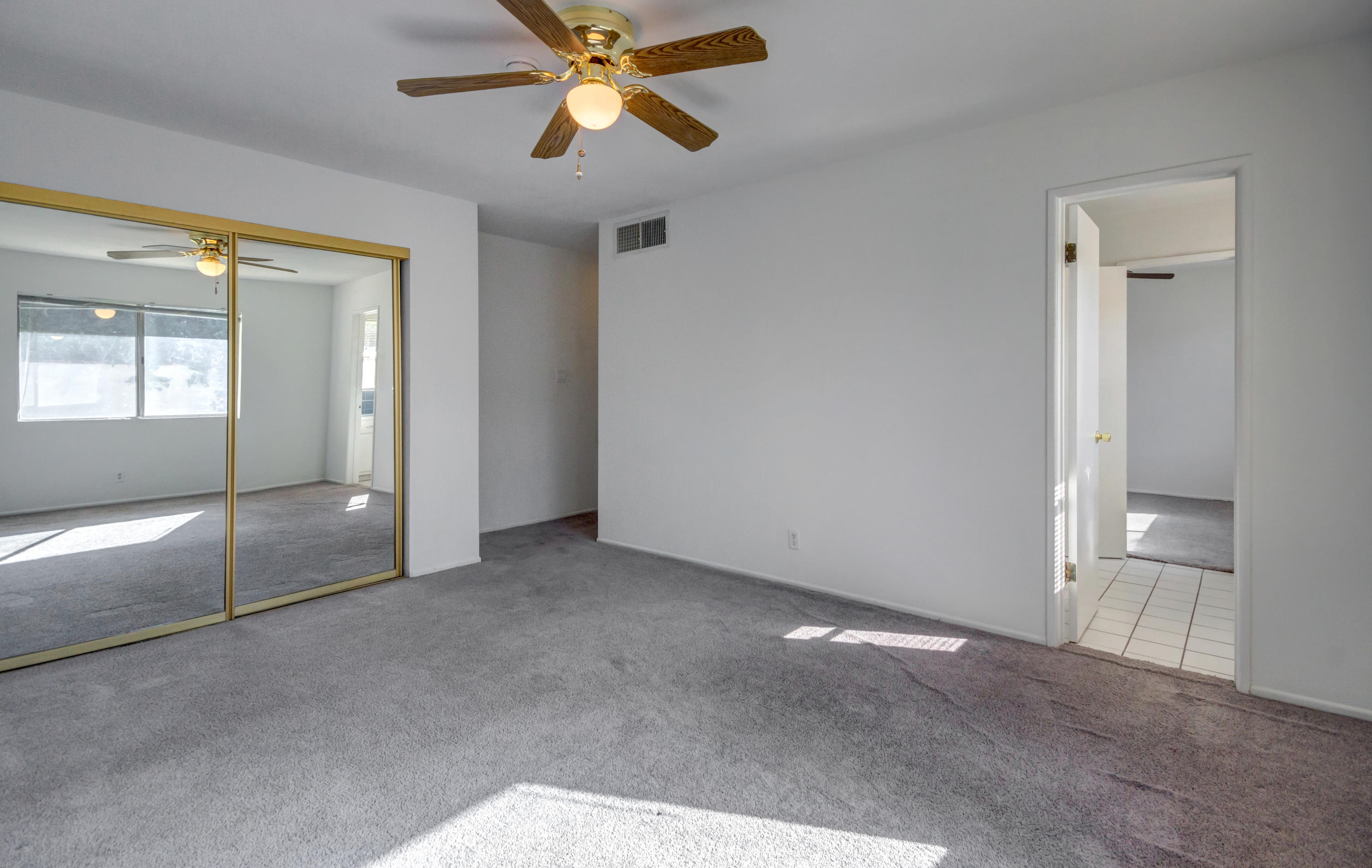 1253 Linda Vista Road Palm Springs, CA 92262 - Photo 24 of 29 an empty room with fan and windows