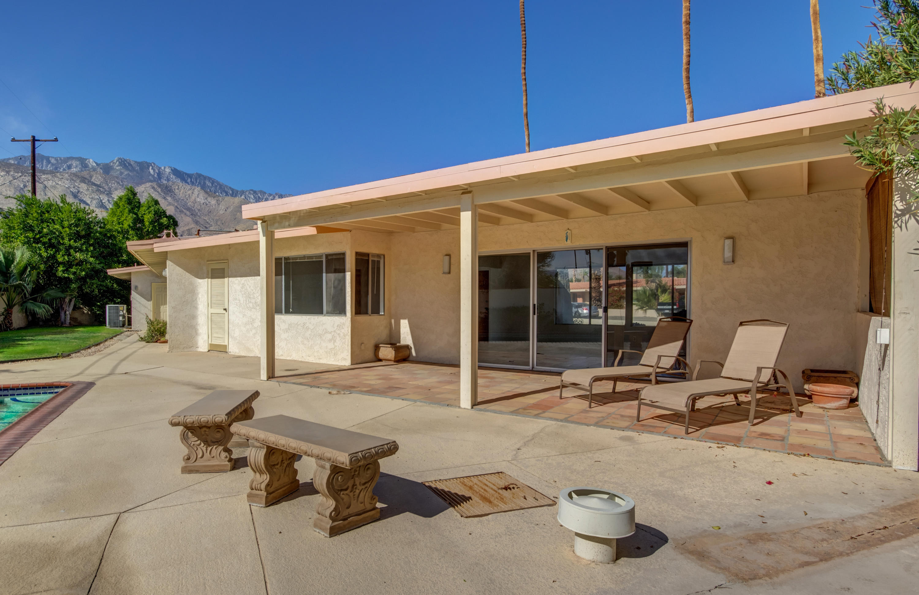 1253 Linda Vista Road Palm Springs, CA 92262 - Photo 25 of 29 a view of a patio with table and chairs and potted plants