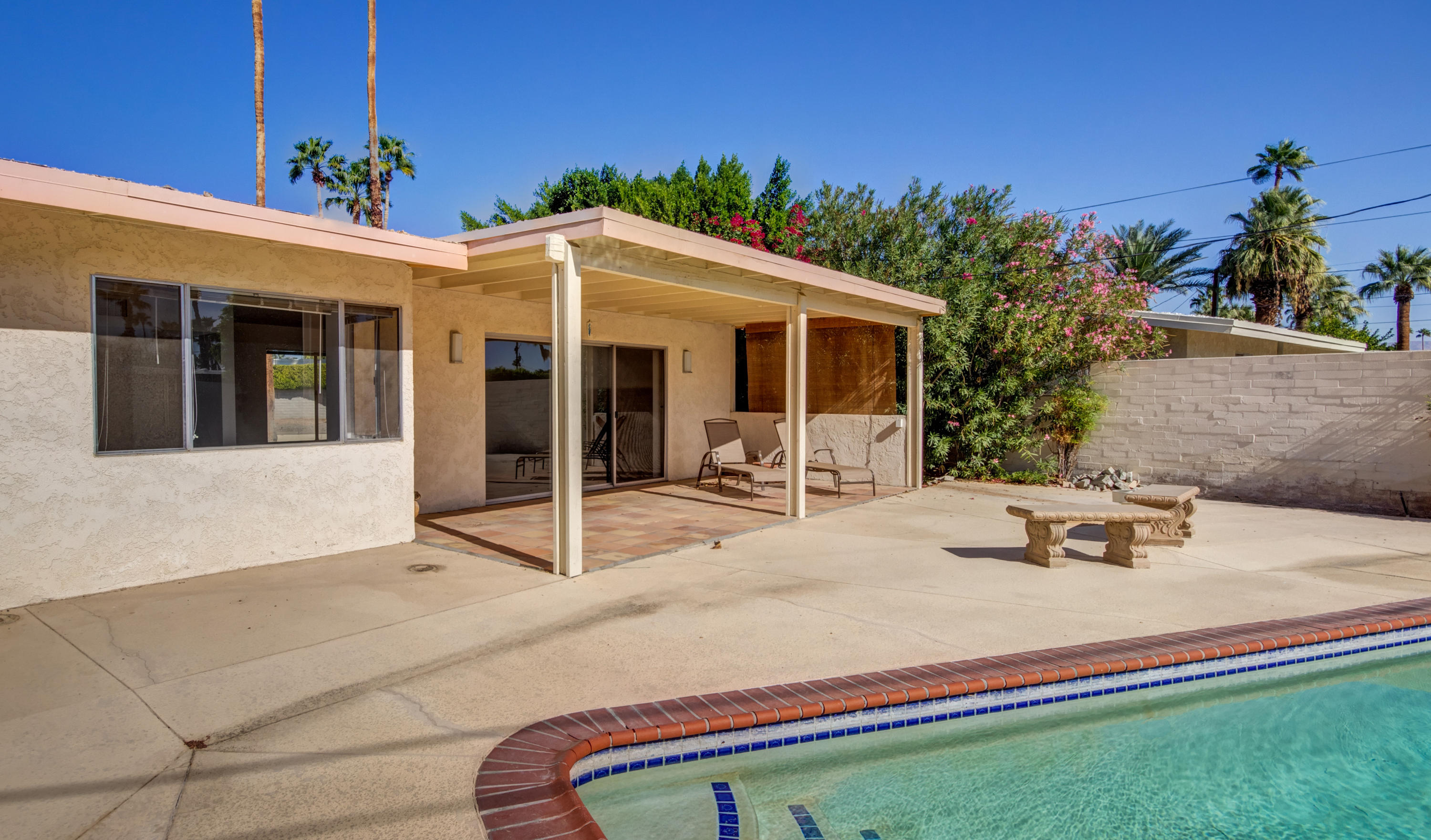 1253 Linda Vista Road Palm Springs, CA 92262 - Photo 27 of 29 a backyard of a house with yard and outdoor seating