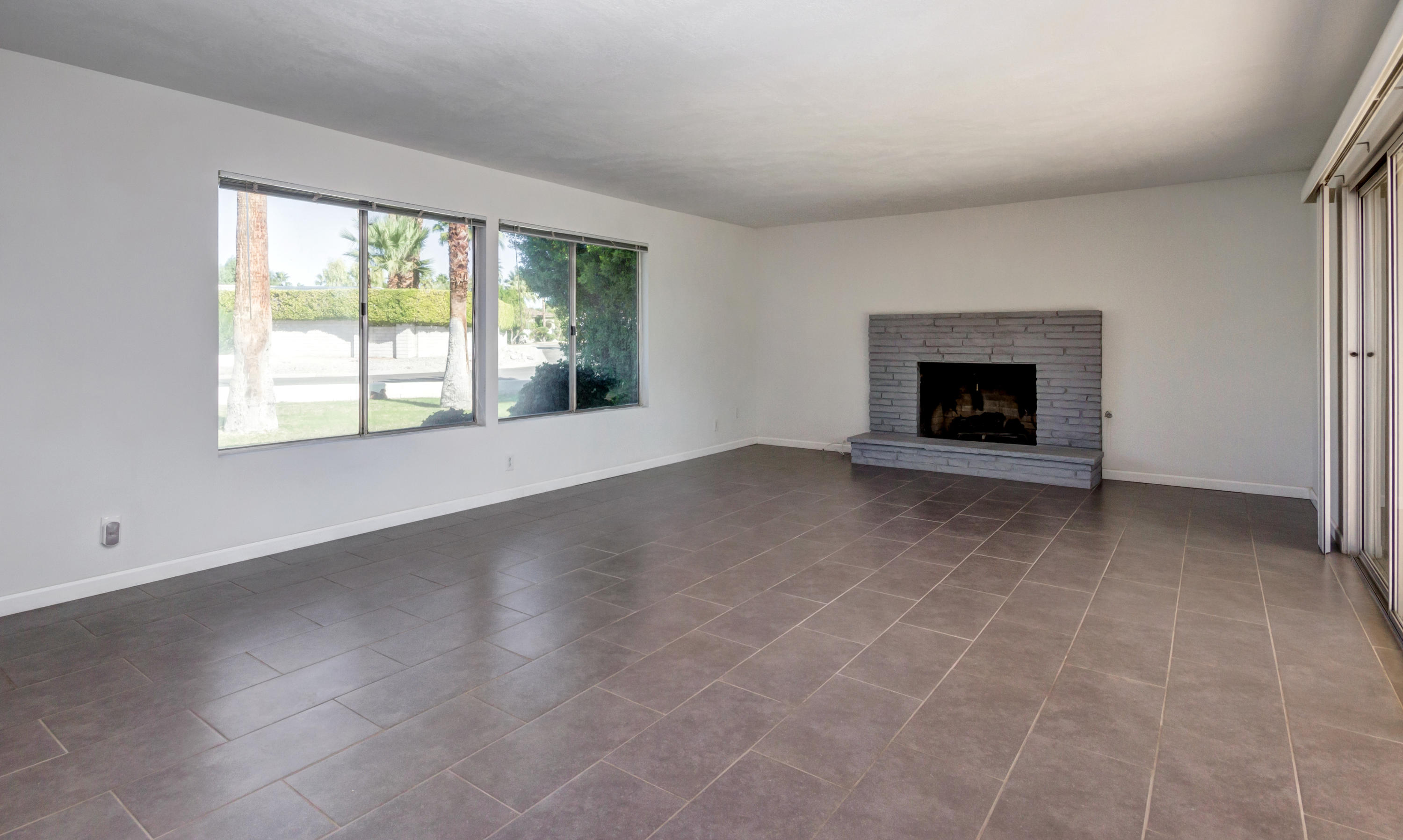 1253 Linda Vista Road Palm Springs, CA 92262 - Photo 7 of 29 an empty room with windows and fireplace