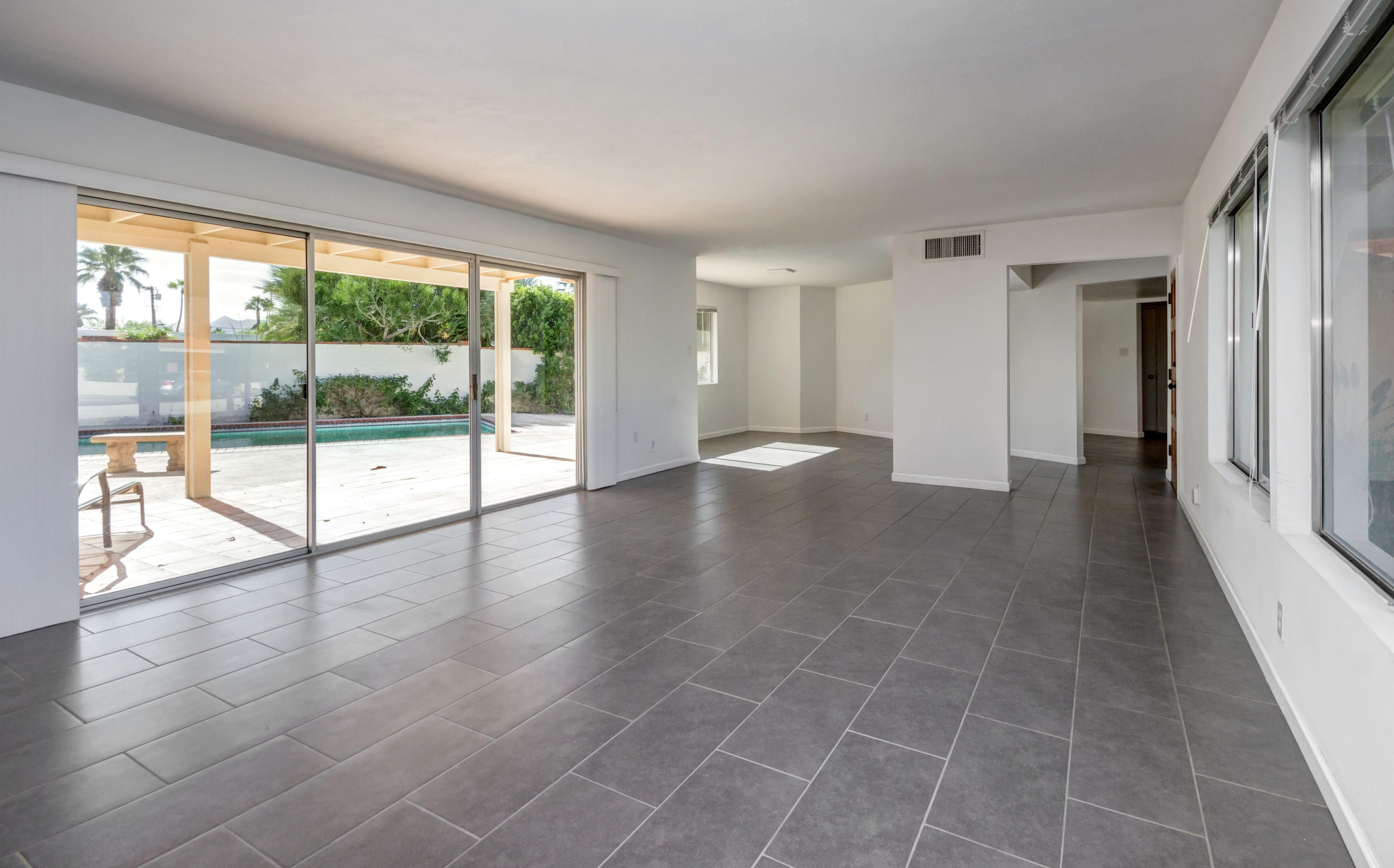 1253 Linda Vista Road Palm Springs, CA 92262 - Photo 9 of 29 wooden floor in an empty room with a window
