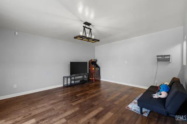 a living room with hardwood floor and a flat screen tv