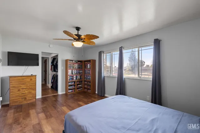 a bedroom with a bed and a television