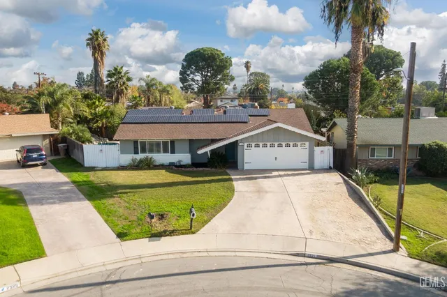 a view of a swimming pool with potted plants and palm trees