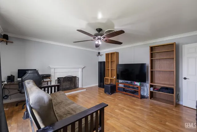 a work room with furniture a fireplace and a flat screen tv