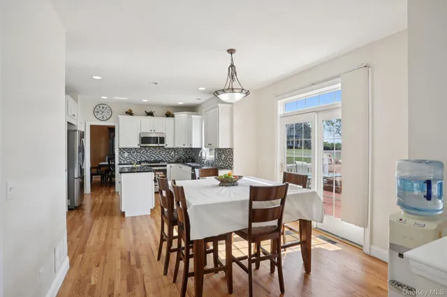 a view of a dining room with furniture wooden floor and chandelier