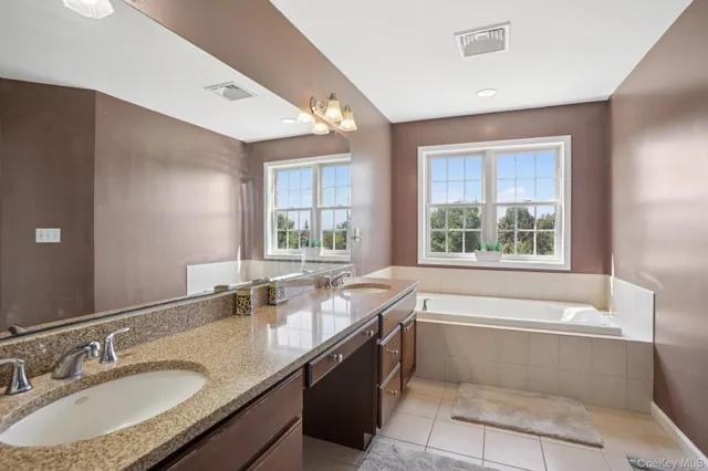 a bedroom with a bed and a mirror