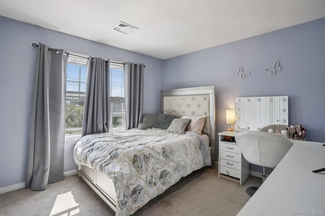 a bathroom with a granite countertop bathtub sink vanity and window