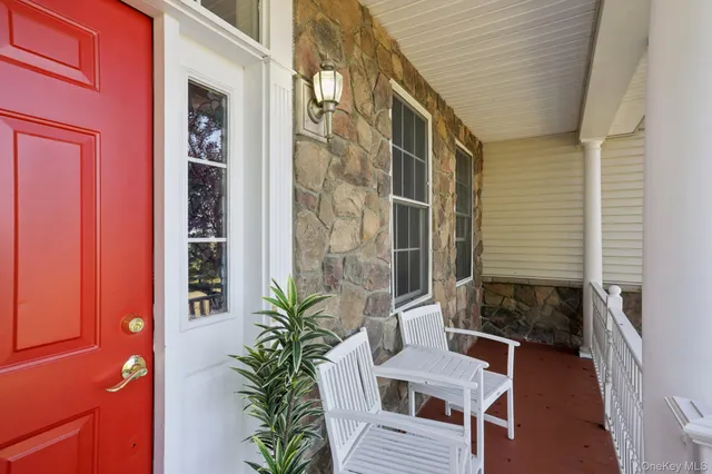 a balcony with furniture and a potted plant