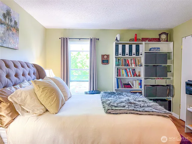 a bedroom with a bed and a book shelf