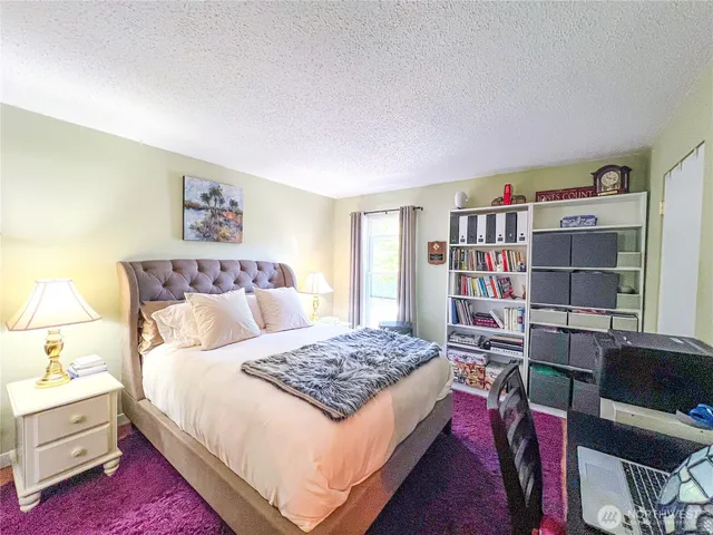 a bedroom with a bed and a book shelf