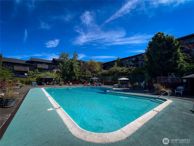 a view of a swimming pool with outdoor seating