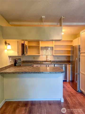 a kitchen with a sink a counter top space and cabinets