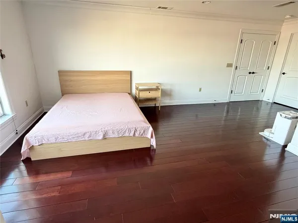 a bedroom with a bed and night stand