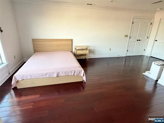 a bedroom with a bed and night stand